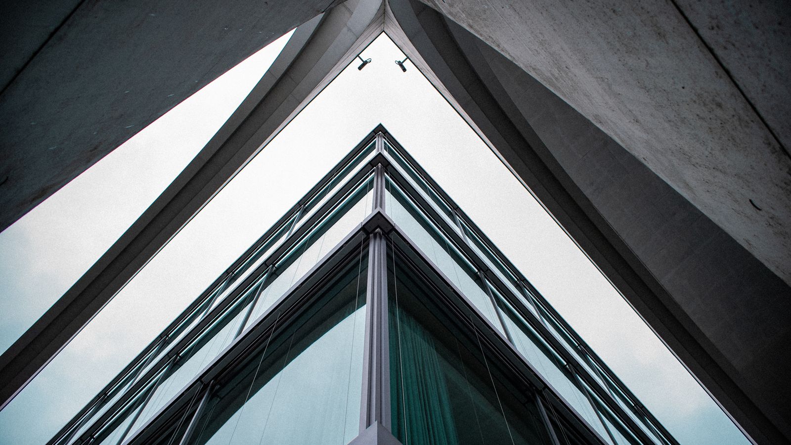 Low-angle view of a glass-and-steel facade receding in ordered lines: an illustrative image for disciplined thinking.